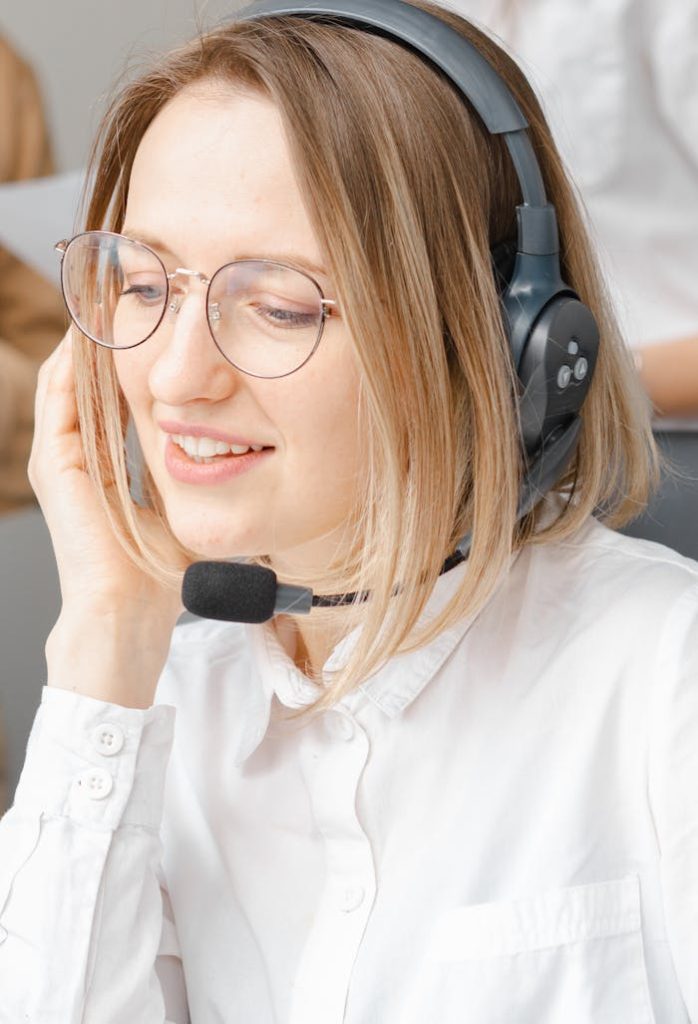 Customer support agent providing service with a smile, using headset.